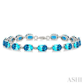 7X5 MM Oval Shape Blue Topaz and 1/10 Ctw Single Cut Diamond Semi-Precious Bracelet in Sterling Silver
