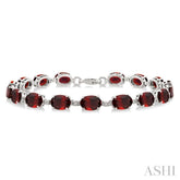 7X5 MM Oval Shape Garnet and 1/10 Ctw Round Cut Diamond Semi-Precious Bracelet in Sterling Silver
