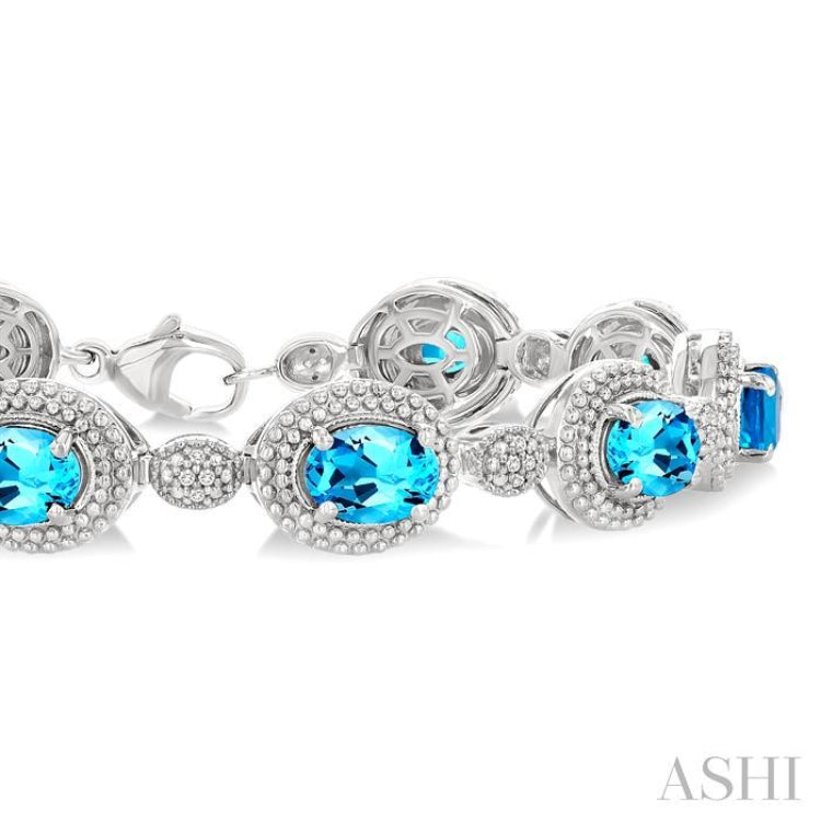 7X5 MM Oval Shape Blue Topaz and 1/10 Ctw Round Cut Diamond Semi-Precious Bracelet in Sterling Silver