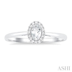 5x3 MM Oval Shape White Topaz and 1/20 Ctw Round Cut Diamond Halo Semi-Precious Ring in 10K White Gold