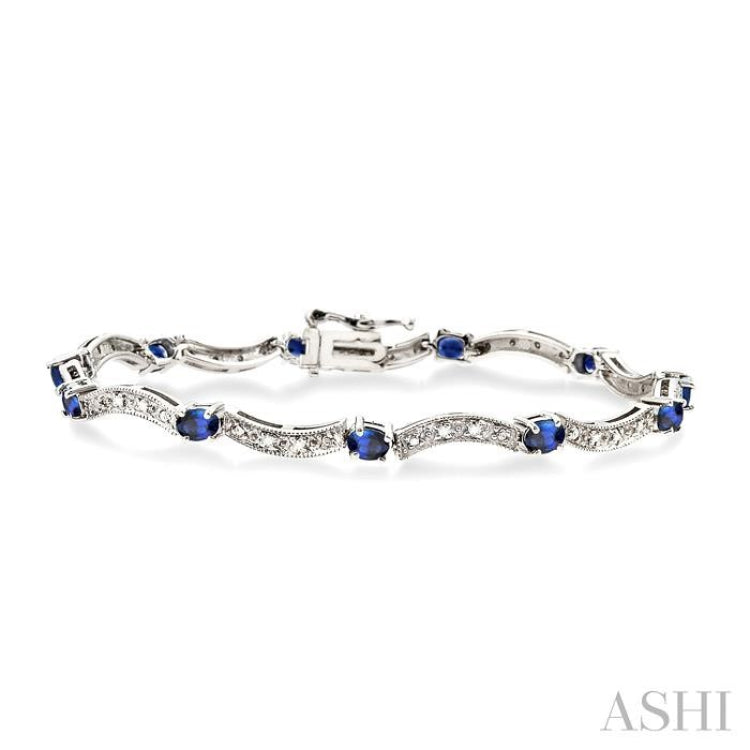 4x3 MM Oval Cut Sapphire and 1/10 Ctw Single Cut Diamond Bracelet in 14K White Gold