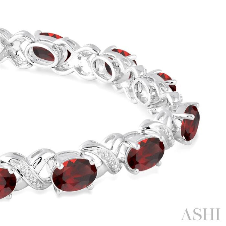 7x5  MM Oval Cut Garnet and 1/20 Ctw Round Cut Diamond Fashion Bracelet in Sterling Silver