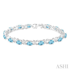 7x5  MM Oval Cut Blue Topaz and 1/20 Ctw Round Cut Diamond Fashion Bracelet in Sterling Silver