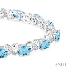 7x5  MM Oval Cut Blue Topaz and 1/20 Ctw Round Cut Diamond Fashion Bracelet in Sterling Silver