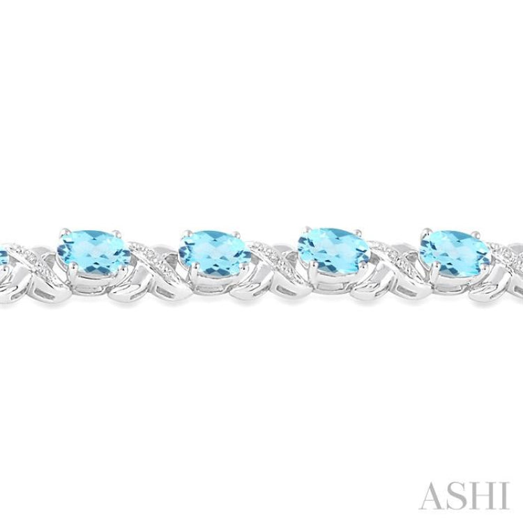 7x5  MM Oval Cut Blue Topaz and 1/20 Ctw Round Cut Diamond Fashion Bracelet in Sterling Silver