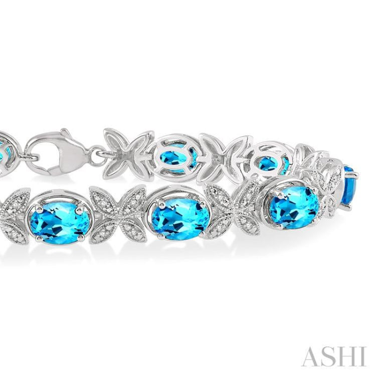 1/10 Ctw Round Cut Diamond & 7x5 MM Oval Cut Blue Topaz Semi Precious Bracelet in Sterling Silver