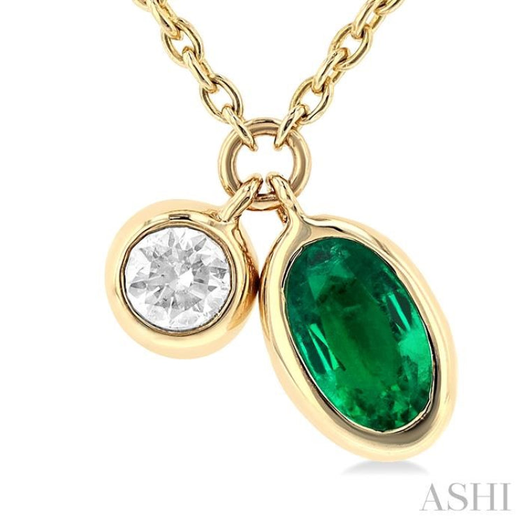 1/50 ctw Oval Cut 5X3MM Emerald and Bezel Set Round Cut Diamond Precious Necklace in 10K Yellow Gold